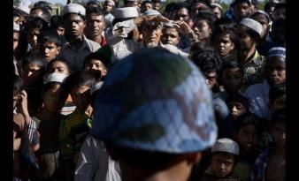 Muslims look out of an internally displaced peoples camp. Photo Credit: Burma Times